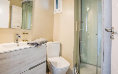 a bathroom with a toilet and a sink and a shower at LUXURY GAVA BEACHFRONT APARTMENT BARCELONA in Gavà