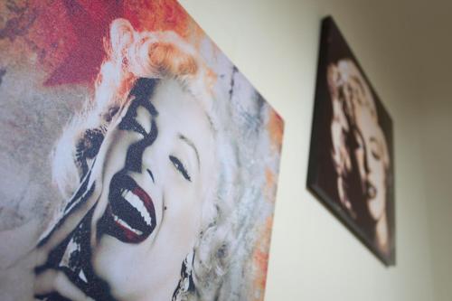 a painting of a woman is on a wall at Hotel Cineholiday in Naples