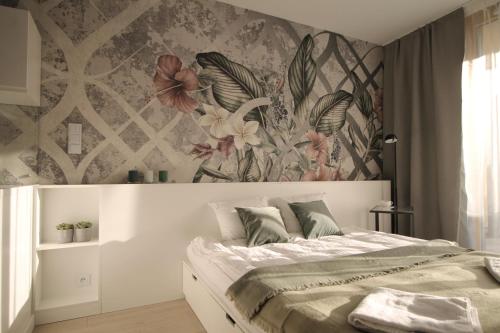 Una cama o camas en una habitación de VIVA Apartamenty