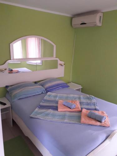 a bedroom with a bed with two towels on it at Bankers Guest House in Veliko Gradište