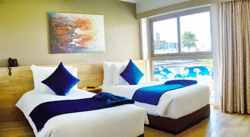 Krevet ili kreveti u jedinici u okviru objekta Mabrouk Hotel and Suites- Adult only