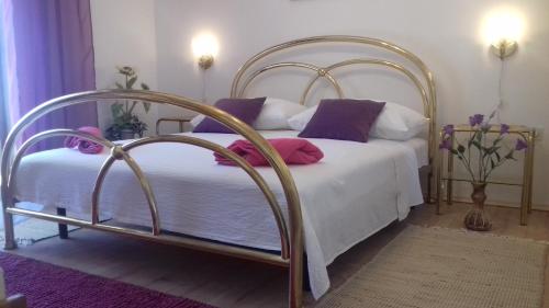 a bedroom with a bed with purple and white pillows at Villa Blue View in Sumpetar