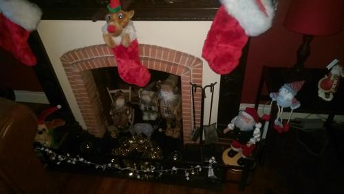 a fireplace with christmas ornaments and christmas decorations at Vingt Grand Rue in Champagne-Mouton