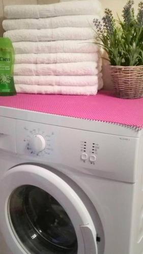 a washing machine with towels on top of it at Nice & Quiet Apartment in Best Area in Alexandroupoli