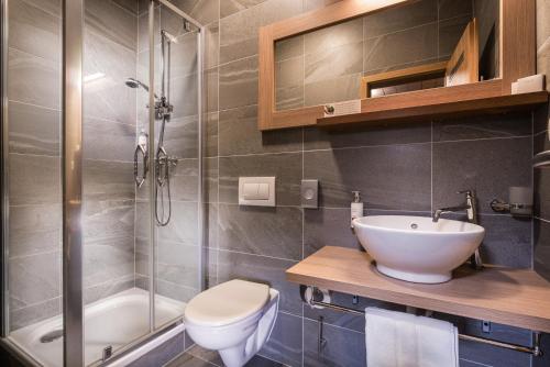 a bathroom with a toilet and a sink and a shower at Hotel Björnson & Björnson TREE HOUSES Jasná in Demanovska Dolina