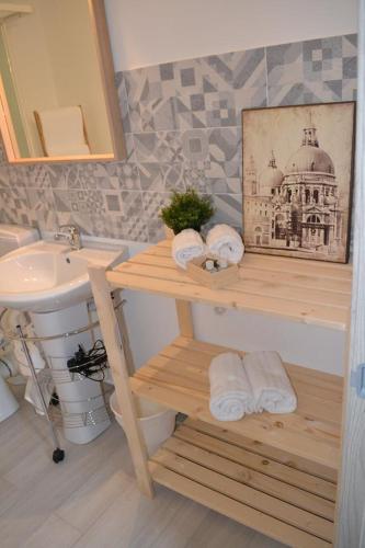 a bathroom with a sink and a counter with towels at Le camere del Corso in Sanremo