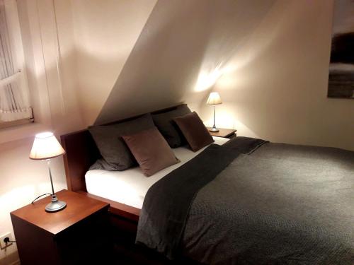 ヴィンターベルクにあるStadtwohnung Schneeflockeのベッドルーム1室(ベッド1台、テーブルにランプ2つ付)