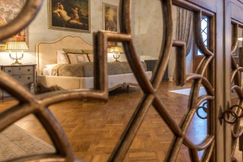 a bedroom with a bed and a mirror at Schloss Fall, Keila-Joa in Keila-Joa