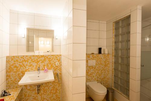 a bathroom with a sink and a toilet at Apartment 1, Rothenburger Straße in Dresden