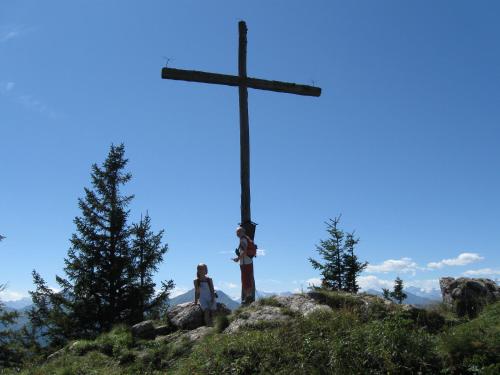 a man standing next to a cross on a hill at Schaidreithof in Grossarl