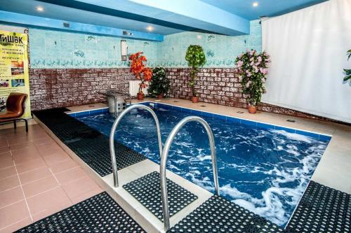 a swimming pool with two faucets in a room at Russ Hotel in Saint Petersburg