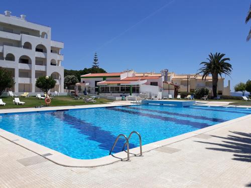 a large swimming pool in front of a building at Dreaming of Algarve in Porches