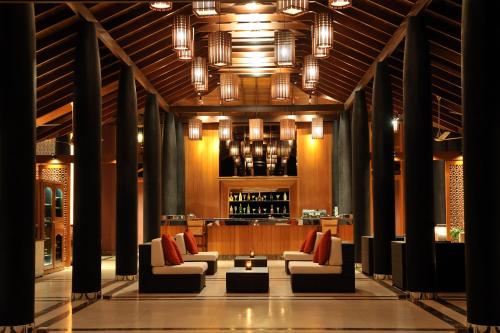 a lobby with couches and a bar in the background at Villa Nautica Paradise Island Resort in North Male Atoll