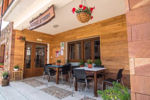 a patio with tables and chairs outside of a restaurant at Albergue de Prioro in Prioro