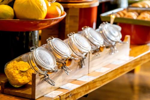 a bunch of pans on a table with fruit at Mercure Sao Paulo Moema Times Square in Sao Paulo