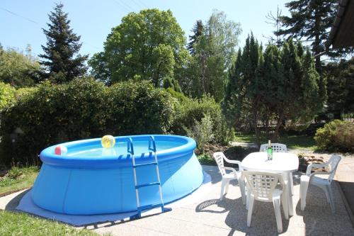 a blue inflatable pool with a table and chairs at Conifer Cottage IdyllicPrague in Prague