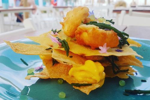 a pile of nachos on a blue plate at Alba Hotel in Marina di Ravenna