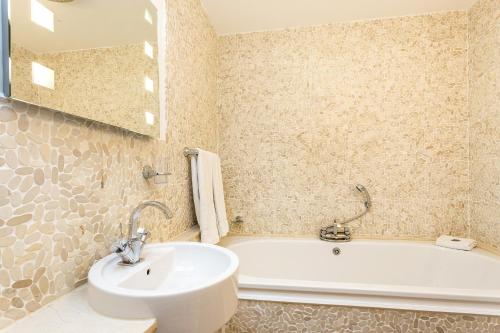 a bathroom with a sink and a bath tub at Riviera Apartments - Five Stylish Penthouse Apartments with Unrivalled Sea Views of Teignmouth, Shaldon, The Jurassic Coastline & The Teign Estuary in Teignmouth