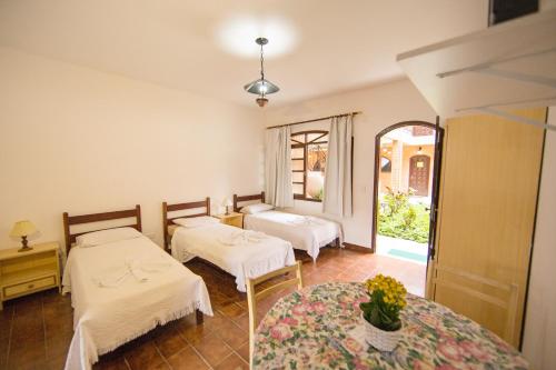 a room with two beds and a window at Elite Hotel in Florianópolis