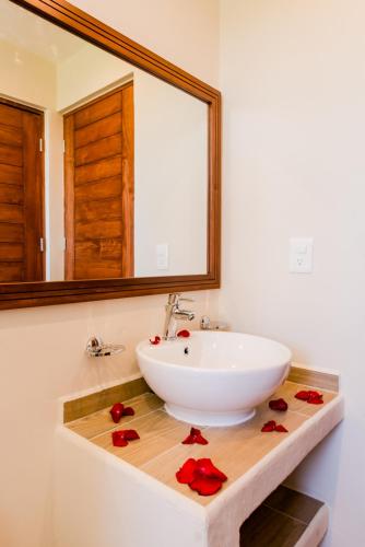 a bathroom with a sink and a mirror at Casa Leo in Playa del Carmen
