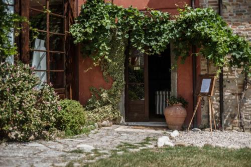 an entrance to a building with a vase in front of a door at Ca' Virginia Country House Wellness in Montecalvo in Foglia