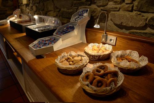a counter with several baskets of food on it at Hotel Pradas Ordesa in Broto