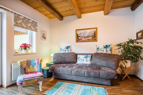 a living room with a couch and a chair at Saghäusl in Mitterkleinarl
