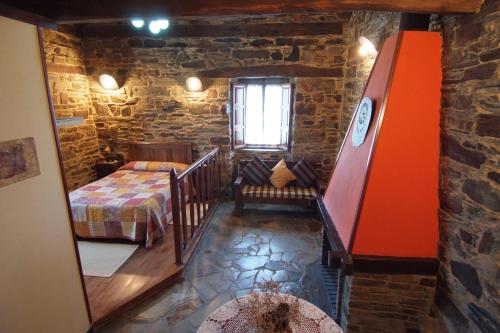 a bedroom with a bed and a staircase in a room at Apartamentos rurales Casa Do Cabo in Vega de Logares