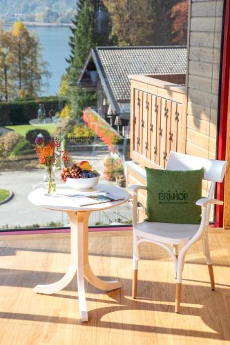 a table and two chairs and a table with a bowl of fruit at Der Erlhof Restaurant & Landhotel in Zell am See