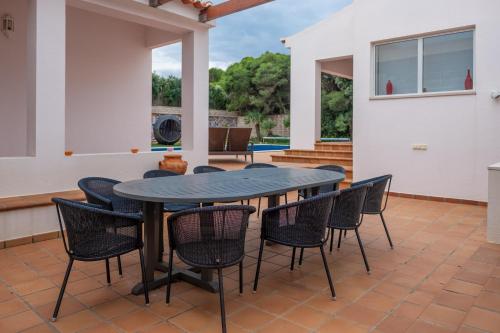 a patio with a black table and chairs at Deslumbrante V6 in Casal da Lagoa Seca