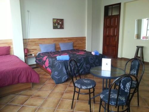 Un dormitorio con una cama y una mesa y sillas. en Hotel Kurtabeg, en Shkodër