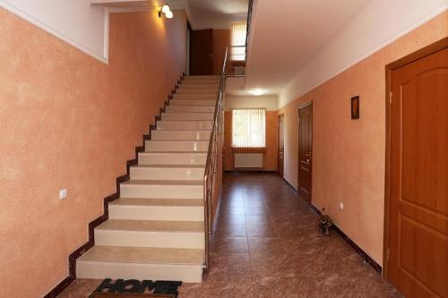 a hallway with stairs in a building with a door at Casablanca Guest House in Koktebel