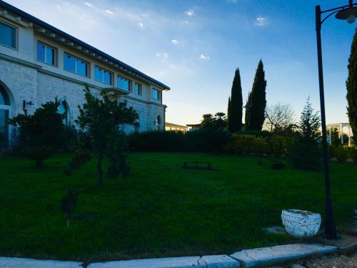 a house with a yard with trees and a park at Zyra Garden Club in Acquaviva delle Fonti