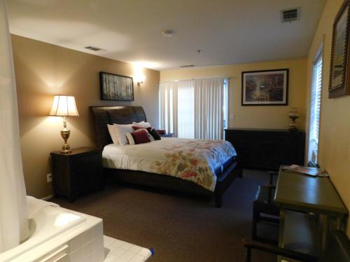 a hotel room with a bed and a bathroom at Freeport Wine Country Inn in Freeport