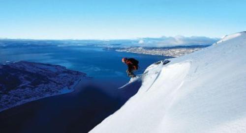 a person is skiing down a snow covered mountain at Thon Partner Hotel Narvik in Narvik