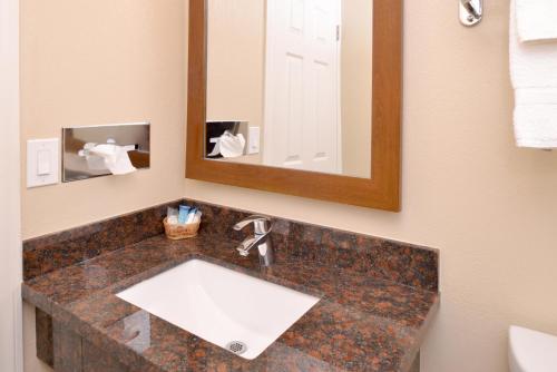 a bathroom with a sink and a mirror at Bay View Inn - Morro Bay in Morro Bay