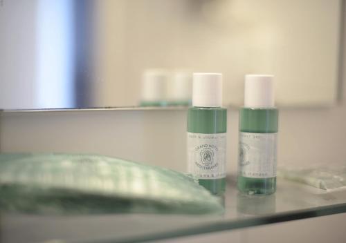two bottles of moisturizers are sitting on a counter at Hotel Mediterranee in Genova