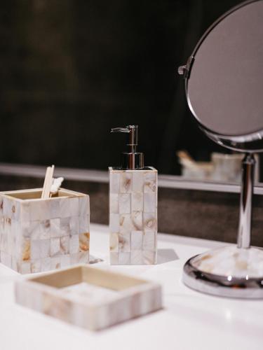 a mirror and two soap dispensers on a counter at Islandijos gatvė in Vilnius
