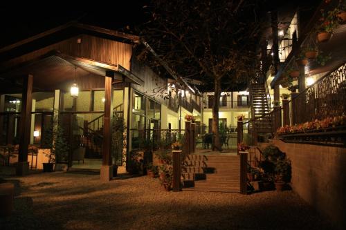 a building lit up at night with a bunch of lights at The Earls Court by Leisure Hotels in Nainital