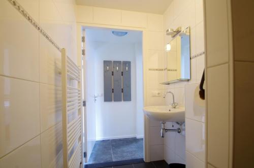 a bathroom with a sink and a mirror at Halte 7 in Kaatsheuvel
