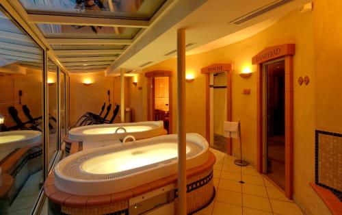 a bathroom with three sinks and three toilets at Hotel Bristol Relais du Silence Superior in Adelboden