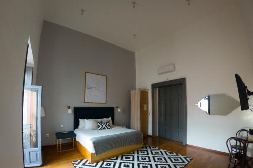 a bedroom with a bed and a television in it at Markee Hotel Boutique in Querétaro