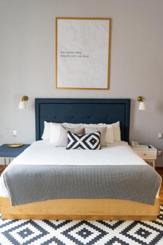 a bedroom with a large bed with two pillows at Markee Hotel Boutique in Querétaro