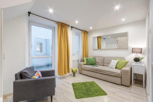 a living room with a couch and a window at Lovely Apartment at Basilica in Budapest