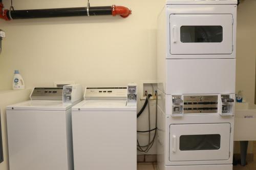 a kitchen with white appliances in a room at Cozy Furnished Studio in Beacon Hill #4 in Boston