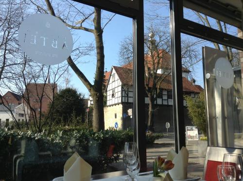 a window of a restaurant with a view of a building at Hotel am Kloster in Werne an der Lippe