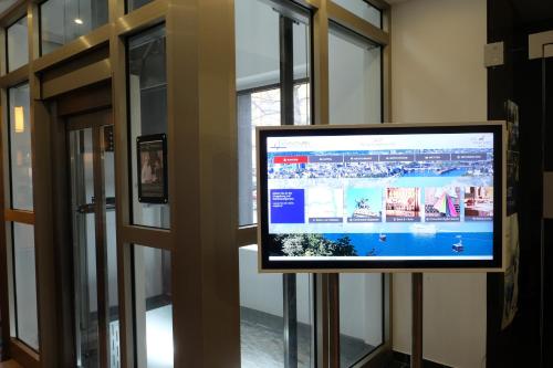 a flat screen tv in a room with windows at Hotel Hohenstaufen in Koblenz