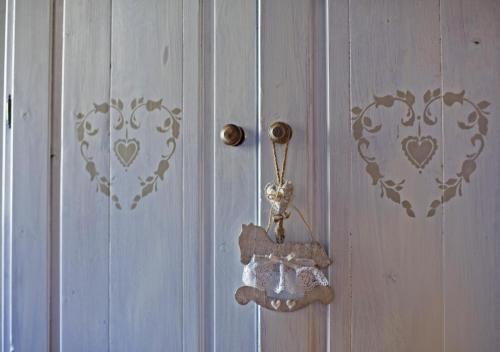 a door with a door knob and a door with hearts on it at Agriturismo La Pedruscia in Civo