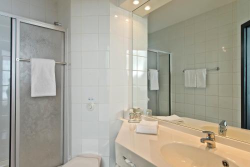 a bathroom with a toilet and a sink and a shower at Days Inn Dessau in Dessau