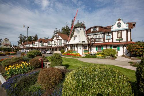 a large building with flowers in front of it at Auld Holland Inn in Oak Harbor